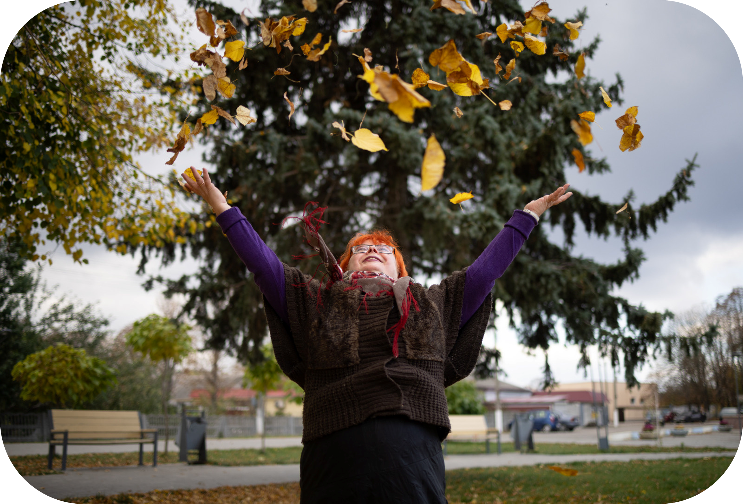 A woman throws leaves in the air